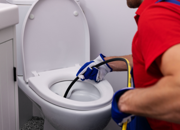 experienced-plumber-from-rob-millar-plumbers-fixing-a-clogged-kitchen-sink-with-professional-drain-cleaning
